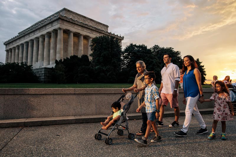 multigenerational family walking at night in front of lincoln memorial ddc photo